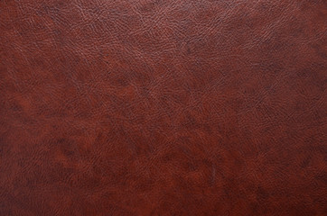 Red, brown leather, skin texture. Background rough, abstract. 