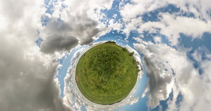 Little planet Transformation with curvature of space. full flyby panorama landscape in field in sunny day with awesome clouds