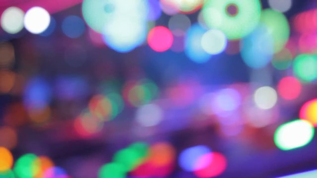 funfair fairground ride rainbow bokeh lights rides moving flashing people at night