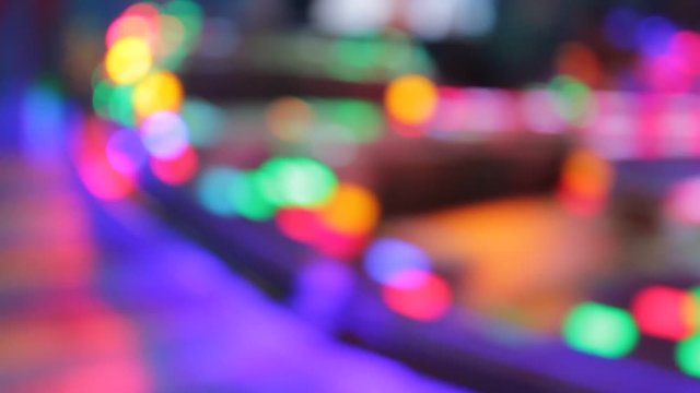 funfair fairground ride rainbow bokeh lights rides moving flashing people at night