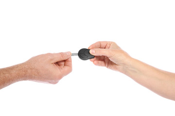 Agent giving car key to man on white background, closeup. Getting driving license