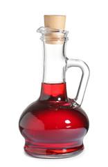 Glass jug with wine vinegar on white background