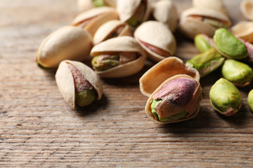 Obraz na płótnie Canvas Organic pistachio nuts on wooden table, closeup