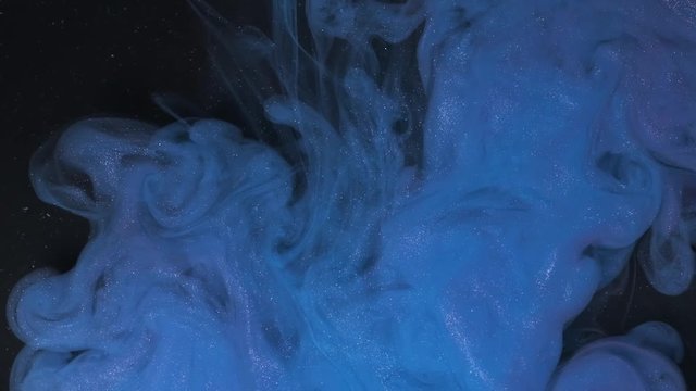 Universe Blue color paint pouring in water. Acrylic colors and ink in water. Abstract frame background. Colors and ink in water