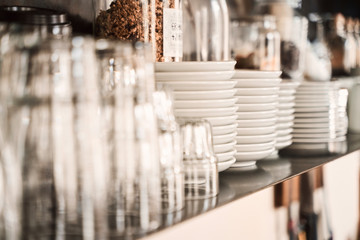 glasses and plates on the shelves of  a stylish modern restaurant. 