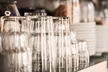 glasses and plates on the shelves of  a stylish modern restaurant. 