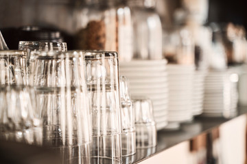 glasses and plates on the shelves of  a stylish modern restaurant. 