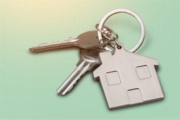 House keys with house figure  on background
