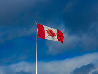 Canadian flag on blue sky