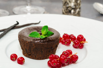 Chocolate fondant. Hot chocolate pudding with fondant center on plate, close-up. Chocolate lava cake with molten center. Lava cake