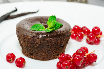 Chocolate fondant. Hot chocolate pudding with fondant center on plate, close-up. Chocolate lava cake with molten center. Lava cake