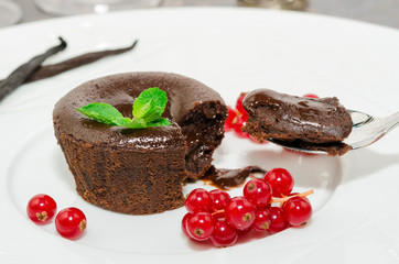 Chocolate fondant. Hot chocolate pudding with fondant center on plate, close-up. Chocolate lava cake with molten center. Lava cake
