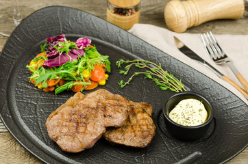 Roasted steak with salad, vegetables and sweet potatoes
