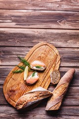 Fresh and healthy food. Snack or lunch ideas. Homemade bread with lemon and salmon served on wooden board