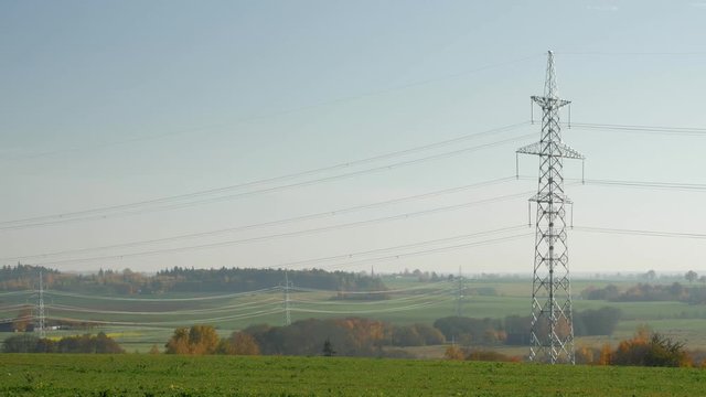 Power lines stretching off into the distance in a rural setting.