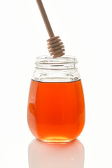 Bee honey with a wooden spoon for honey.isolated objects on white background