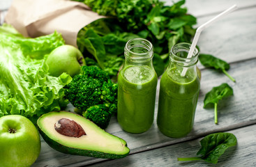 smoothie with vegetables, avocado, apple, kiwi on a wooden background. sports nutrition