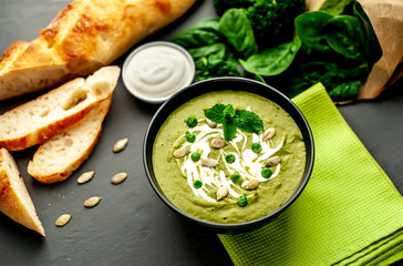 Green cream soup of spinach and broccoli. concrete or slate background. The concept of a healthy diet and diet.