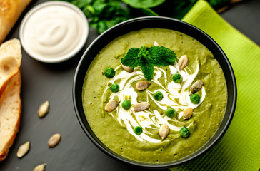 Green cream soup of spinach and broccoli. concrete or slate background. The concept of a healthy diet and diet.
