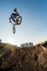 Fototapeta na wymiar BMX Bike jump over a dirt trail