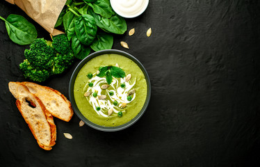 Green cream soup of spinach and broccoli. concrete or slate background. The concept of a healthy diet and diet.