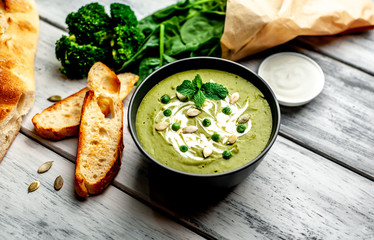 Green cream soup of spinach and broccoli. wooden background. The concept of a healthy diet and diet.
