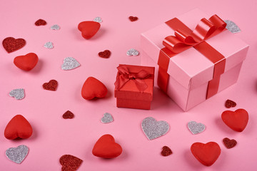Gift box on pink background made hearts. Valentine background