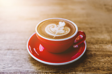 red cup of hot latte coffee with latte art