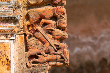 Terracotta art on the wall of Hindu temple , India