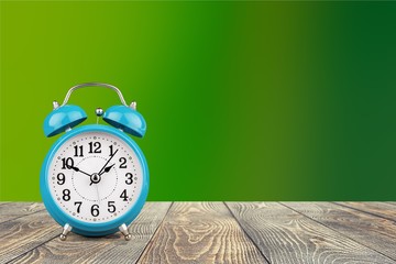 Retro alarm clock on table  background