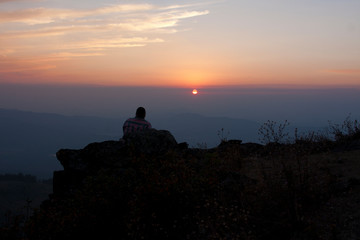 Fototapeta na wymiar A man in silhouette watching the sunset