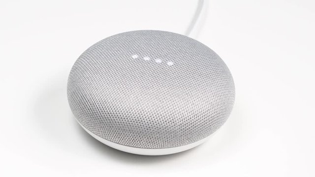 Camera focusing on a smart assistant being voice activated for many smart home features.