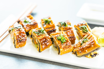 Grilled eel or unagi fish sushi maki roll with sweet sauce