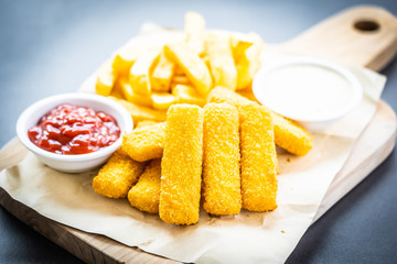 Fish finger and french fries or chips with tomato ketchup and mayonnaise sauce