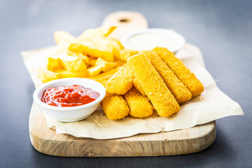 Fish finger and french fries or chips with tomato ketchup and mayonnaise sauce