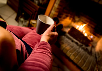 woman is warming in a fireplace
