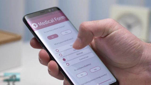 User filling a medical form on his smartphone screen. Closeup on the device.