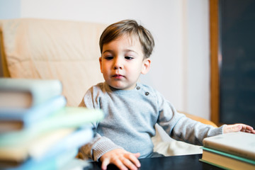 Little Boy PLaying With Books Reading