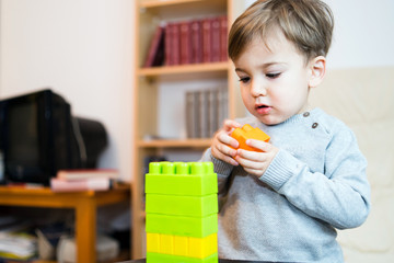 little boy playing with toy blocks