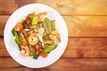 Green salad with shrimps on background