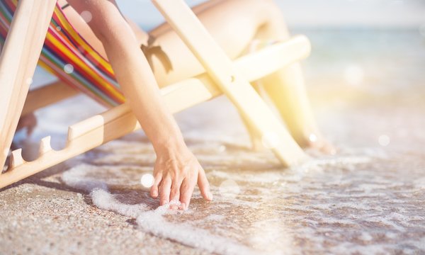 Woman At Beautiful Beach Relaxing On The Chair