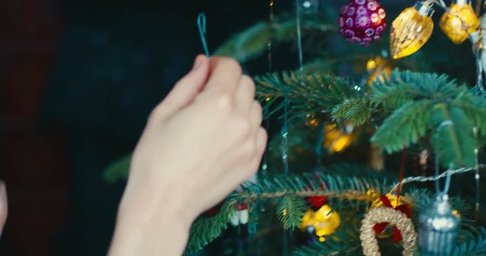 Young woman decorating christmas tree