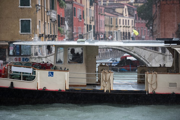 Portrait of Venice tourist boat in rainy day.
