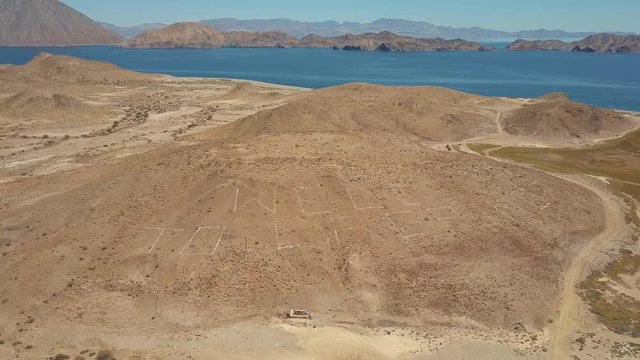 Wide Aerial View, "Welcome to La Gringa" on countryside, beautiful view of coastline and pristine beach. Bahia de los Angeles, Baja California, Mexico