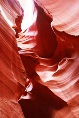 Nature red sandstone textured background. Swirls of old red sandstone wall abstract pattern in Lower Antelope Canyon, Page, Arizona, USA. Vertical composition.