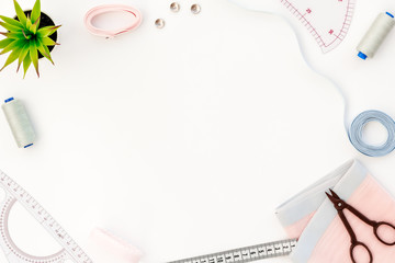 Tailor work place with thread, scissors, fabric. Sewing as hobby. White background top view space for text