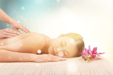 Beautiful young woman relaxing with  massage at beauty spa