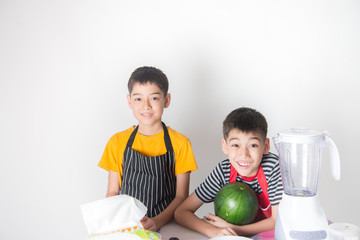 Fototapeta premium Little boys blend water melone juice by using blender at home