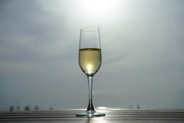 champagne glass with blurred sea and sky background
