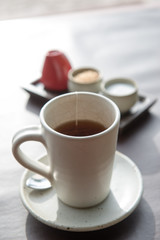 Hot tea served in a mug with milk and sugar